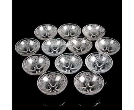Twelve striking crystal bowls in a seashell design with opalescent accents. Three are clear and nine have a light tan hue. R 