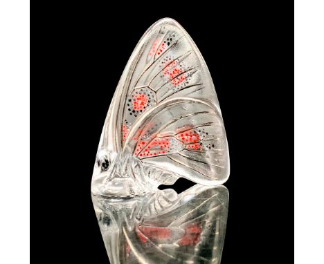 A clear crystal butterfly that has black and red dots scattered throughout with rhodium lining. Signed Lalique France. This i