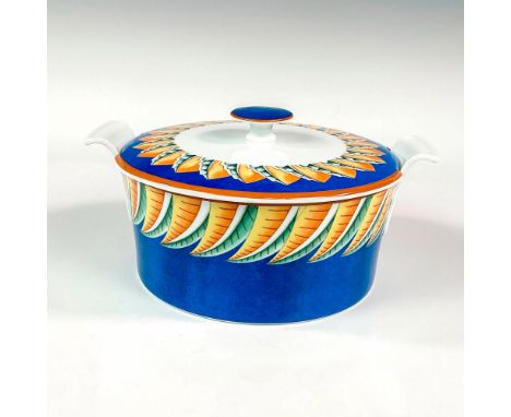 Discontinued pattern. Elegant and lightweight porcelain tureen with swooped handles and knobbed lid. Design features a cerule