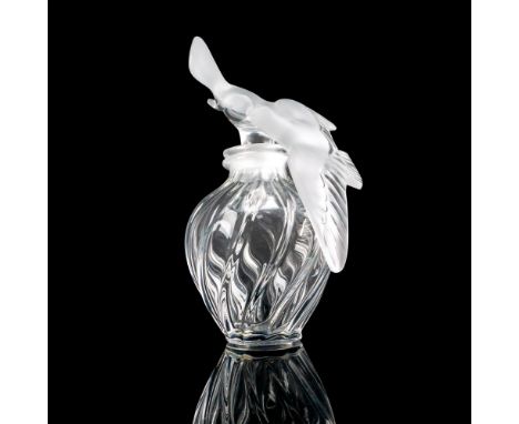 A large clear bottle with a swirl design, adorned with a stopper sculpted as two doves in a frosted satin finish. Artist: Mar