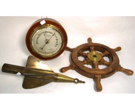 An early 20th century brass 'Cherub' harpoon ships log, a decorative ships steering wheel with brass centre, diameter 40cm an