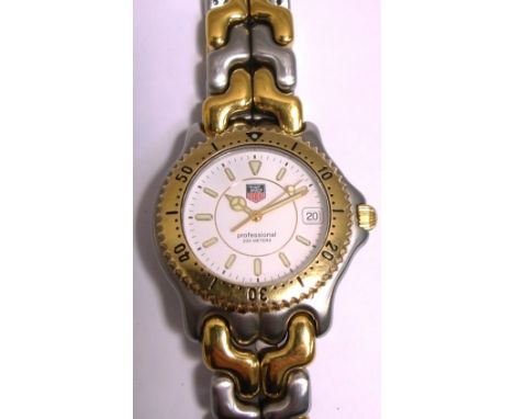 Tag Heuer; a gentlemans white and yellow metal wristwatch, enamel dial set with batons.