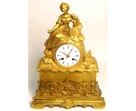A 20th century Continental gilt heightened eight day striking spelter mantel clock, enamel dial set with Roman numerals, heig