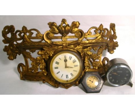 The front section from a gilt heightened mantel clock with enamel dial set with Roman numerals, a Jaeger car clock and a Geor