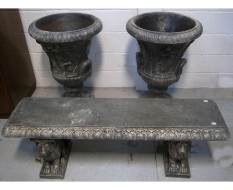 Two reconstituted stone decorative garden urns, height of each 80cm and a matching garden bench with supports in the form of 