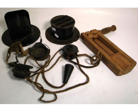 A gas alarm warning rattle, later used as a football rattle, and two WWII vehicle light diffusers.