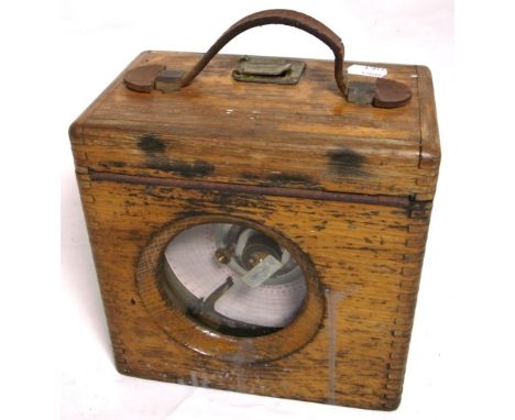An oak cased pigeon timing clock with brass fittings and leather carrying handle.