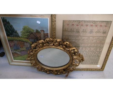 A mid 19th century sampler of the alphabet by Bessie Brown, framed and glazed, a small oval gilded mirror and a c. 1940s tape
