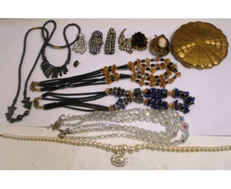 A small quantity of costume jewellery to include a crystal necklace, vintage dress clips, a compact, a Victorian pinchbeck ca