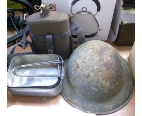 A mid 20th century British Infantryman's helmet complete with liner, a water bottle in original felt cover with shoulder stra