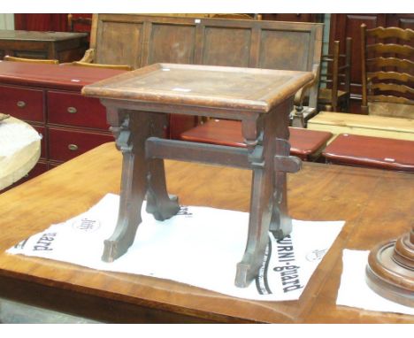 A Victorian Gothic oak stool.