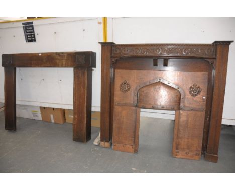 An Early 20th century copper fire surround with an oak mantle piece and a second oak mantle piece. (2)