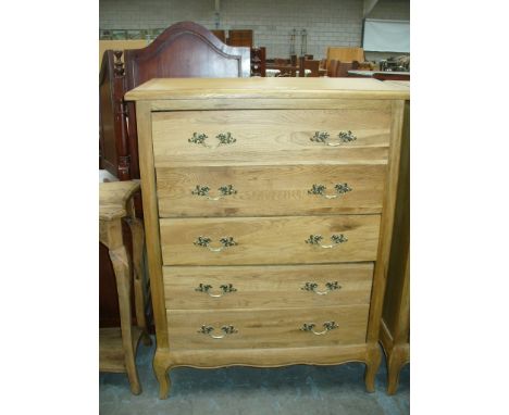A Light oak French style chest of six drawers.