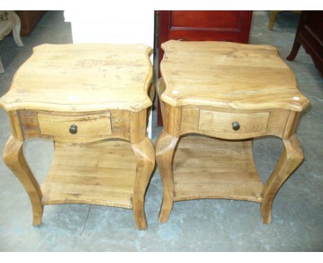 A Pair of light oak rustic side tables each with a frieze drawer and shaped under shelf.