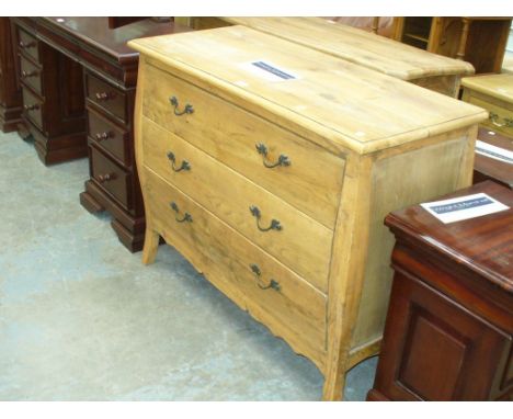 A Light oak bombe style three drawer chest.