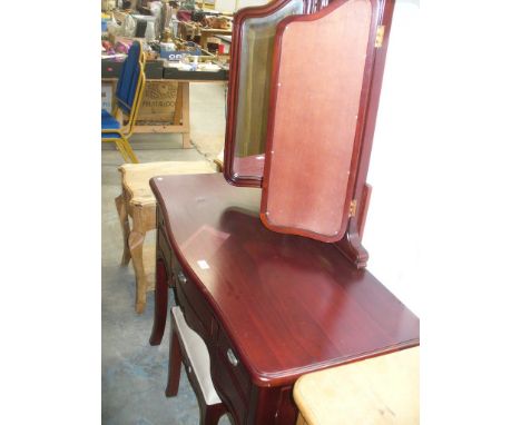A Stained wood French style dressing table with a triple mirror above a serpentine top , three frieze drawers and a conformin