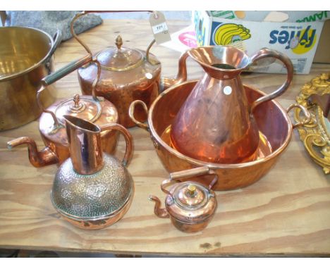 A Victorian copper kettle , two smaller examples, a Loveridge & Co bulbous copper jug, a 19th Century copper haystack measure
