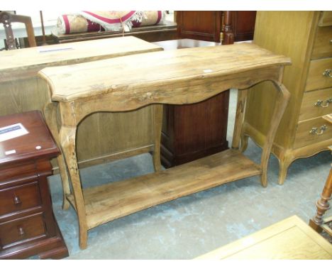 A Rustic light oak console table with a shaped under shelf.