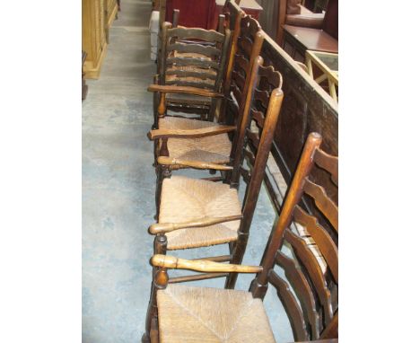 An 18th Century oak and rush seated Macclesfield ladder back chair ,  second similar chair , a later elbow chair and 3 reprod