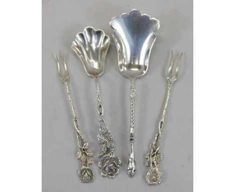 Continental white metal caddy spoons, and a pair of small forks.