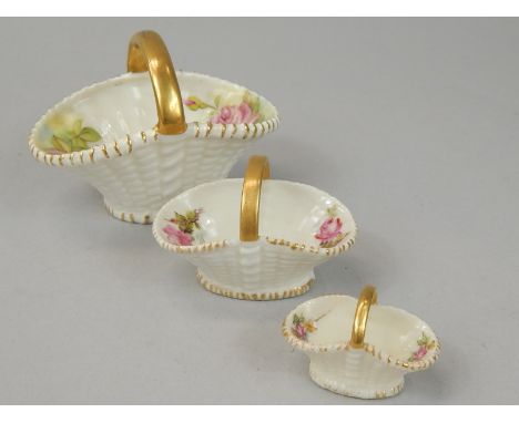 An associated set of three Royal Worcester porcelain baskets, each decorated with roses, printed marks in puce to underside, 