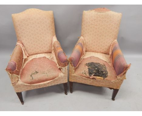 A pair of late 19thC / early 20thC mahogany armchairs, each with square tapering legs, and ceramic castors, upholstery (AF).