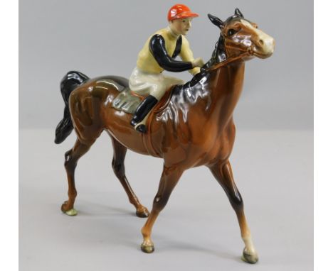 A Beswick ceramic model of a racehorse and jockey, in walking pose, brown colourway number 2, with number 24 painted to saddl