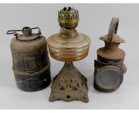 A collection of bygones, to include a Victorian oil lamp with painted cast metal base, two railway type paraffin lamps, one b