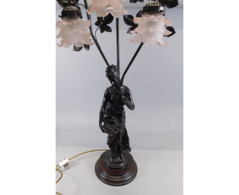 A modern bronzed lamp base, with three glass shades, the base mounted with an Art Nouveau style maiden carrying fruit, 85cm h