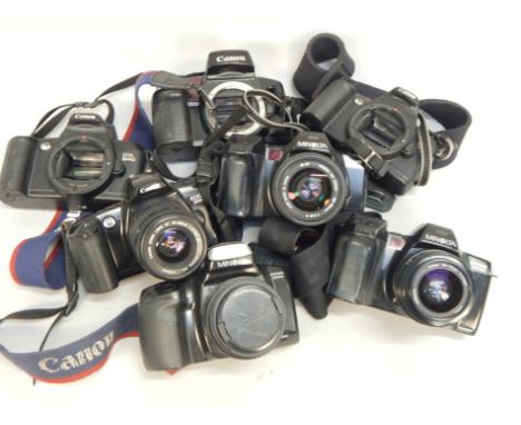 Various Minolta and other cameras, two Dynax 7000I , Dynax 300SI, each with a lens, Canon Eos cameras, and a lenses. 