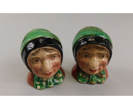 A pair of Beswick salt and pepper pots, featuring lady in head dress, each with cork base, stamped with black Beswick England