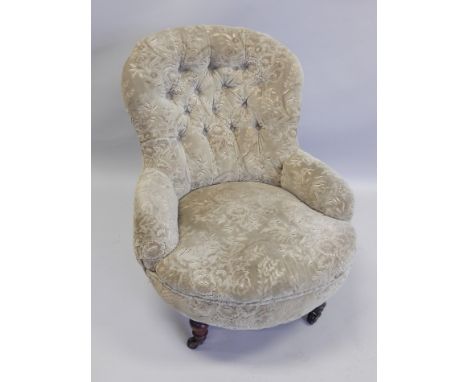 A Victorian mahogany armchair, upholstered in buttoned dralon type fabric, on turned legs with ceramic castors.