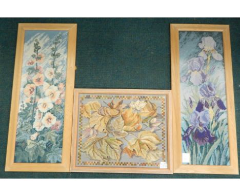 Three tapestry type embroidered pictures, each depicting flowers and leaves, various sizes.