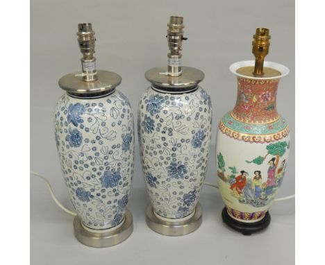 A pair of modern Oriental style table lamps, with raised decoration in blue and white, 46cm high, and a modern Chinese style 