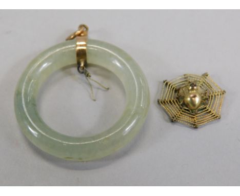 A jade pendant, with central spider pendant, yellow metal, marked 14ct, 10g all in.