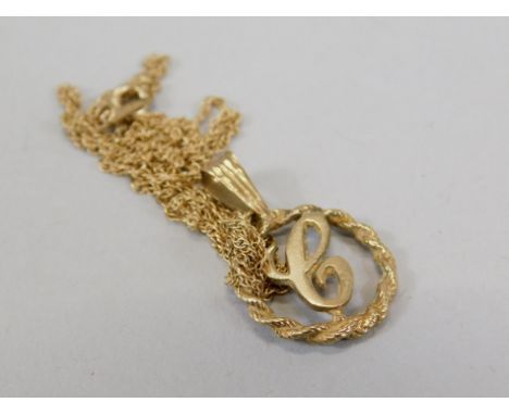 A 9ct gold ladies pendant and chain, the pendant of the letter C, in rope twist circular surround, on fine link chain, 1.9g a
