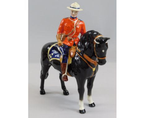 A Beswick ceramic Canadian Mountie, with a black horse, modelled by Arthur Gredington, 21cm high.