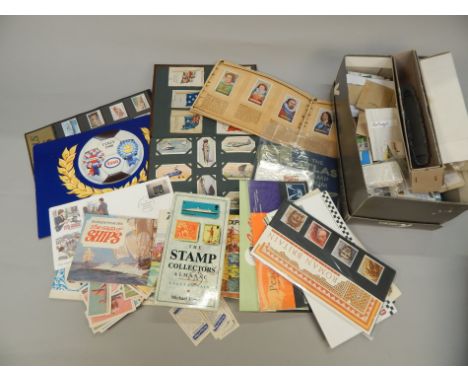 A quantity of cigarette cards, trade cards, a small amount of stamps etc.