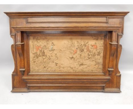An early 20thC oak over mantel mirror frame, inset with a machine woven tapestry hunting scene, 144cm wide.