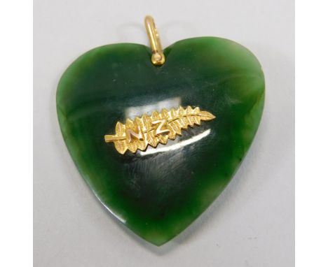 A heart shaped jade pendant, with attached gold leaf and initials NZ, 8cm wide, 14.8g all in.