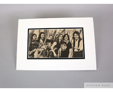 A mounted black and white photographic print of Wings&nbsp;&nbsp; signed in pen by Linda McCartney and measuring 9 x 1in. and
