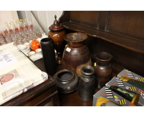 A collection of various African and other wooden and ceramic vases; and an urn 