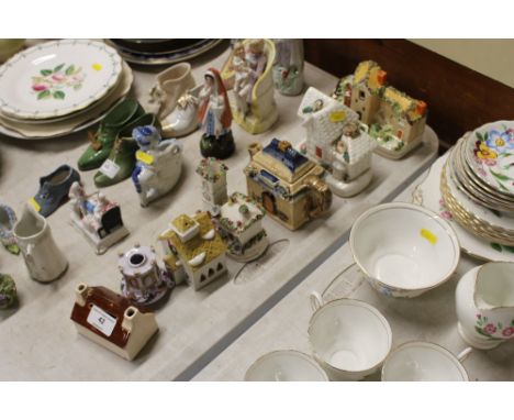 Seven various Staffordshire and other model houses; and a novelty teapot 