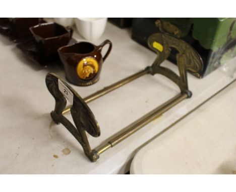 An Art Nouveau brass extending book rack 