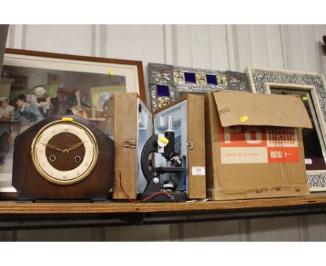 A projector - sold as collector's item; together with a Lunax microscope in fitted case; and a two hole mantel clock 