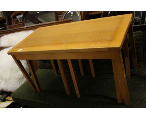 A nest of light oak tables 