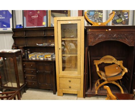 A tall light oak and glazed cabinet 