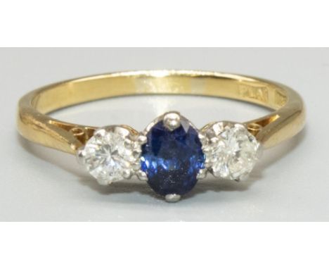 18ct yellow gold and platinum sapphire and diamond three stone ring, the central oval cut sapphire flanked on either side by 