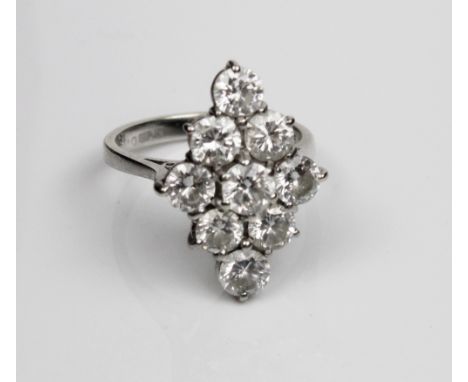 18ct white gold diamond cluster ring, the nine brilliant cut diamonds in claw settings on plain shank, stamped 750, size L, 4