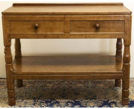 Robert "Mouseman" Thompson of Kilburn - oak two tier side table, low gallery back with adzed top above two drawers with turne